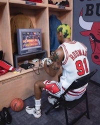 a chicago bulls player is playing a video game in a locker